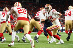 Jimmy Garoppolo #10 hands off to Jeff Wilson Jr. #22 of the San Francisco 49ers during the second half against the Denver Broncos at Empower Field At Mile High (Picture: Jamie Schwaberow/Getty Images)