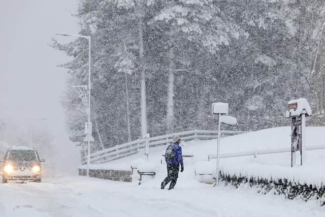 People walk through snow. (Pic credit: Jeff J Mitchell / Getty Images)