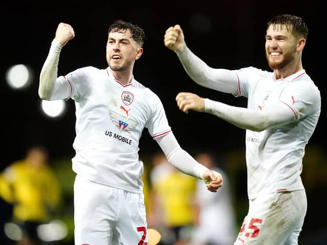 BIG NIGHT: Barnsley's Corey O'Keeffe (left) and John McAtee celebrate at the final whistle after beating hosts Oxford United at the Kassam Stadium. Picture: David Davies/PA