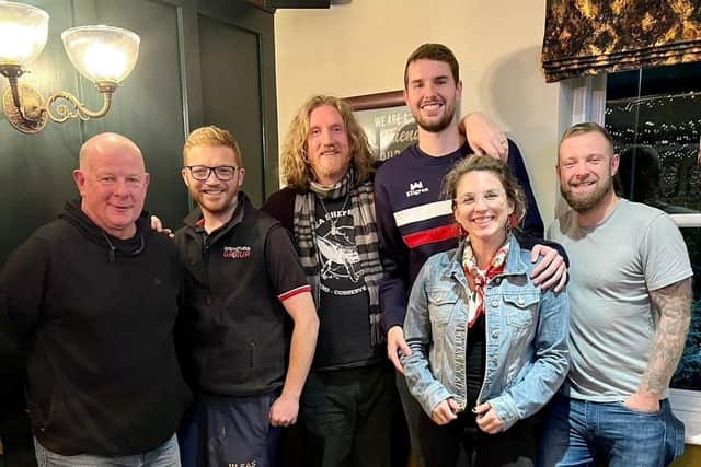 Ian Webb (centre, tall), with wife Megan Webb (jean jacket) at the pub after their game was postponed on October 24 in Wakefield.