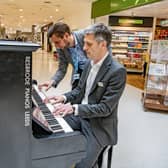 Leeds-based piano firm Besbrode Pianos have donated a piano to Bradford Royal Infirmary for the benefit of patients and staff.Director of Estates and Facilities, Mark Holloway and Deputy Chief Executive of Bradford Teaching Hospitals John Holden  play the new piano on the concourse, photographed by Tony Johnson for the Yorkshire Post. 29 March 2023.