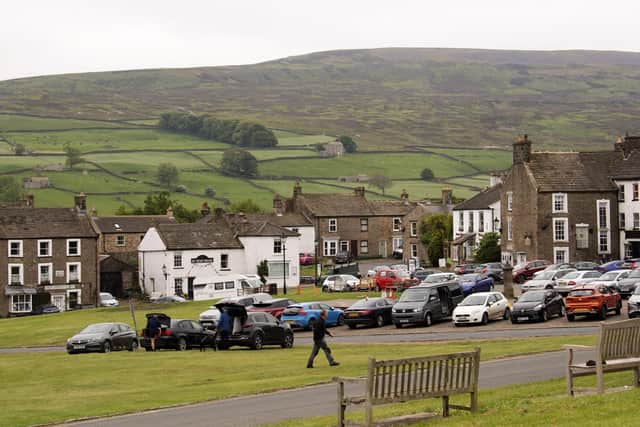 Village feature Reeth. The cobbles square in the centre of Reeth is a hive of local and visitor activity - just as it would have been hundreds of years ago. Picture taken by Yorkshire Post Photographer Simon Hulme 31st May 2023