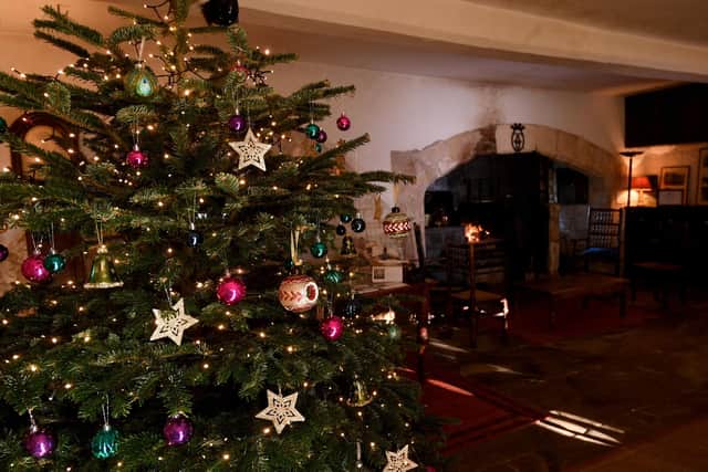 A tree dressed for Christmas in one of the oldest rooms which boasts an original medieval fireplace