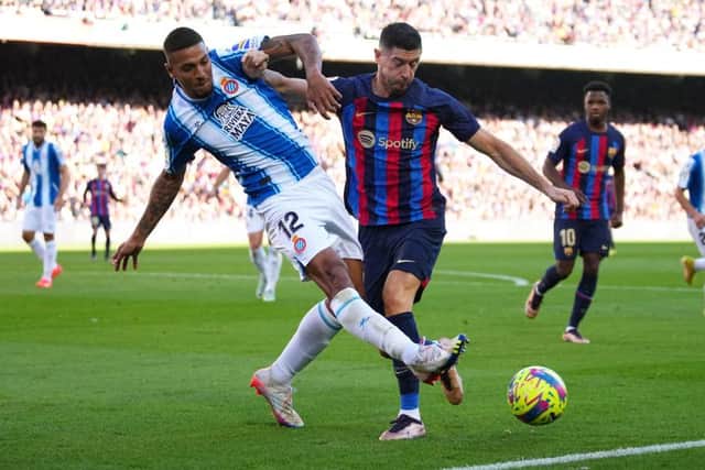 TOUGH TACKLER: Vinicius Souza leaves his mark on Robert Lewandowski when playing for Espanyol last season