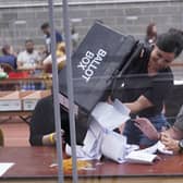 Votes are emptied from ballot boxes onto the tables during a count. PIC: Danny Lawson/PA Wire
