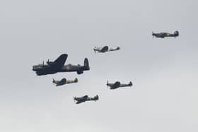 A Second World War Lancaster bomber and spitfires fly in formation. (Pic credit: Oli Scarff / AFP via Getty Images)