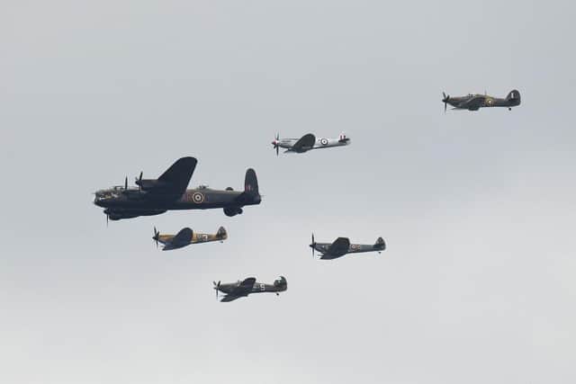 A Second World War Lancaster bomber and spitfires fly in formation. (Pic credit: Oli Scarff / AFP via Getty Images)