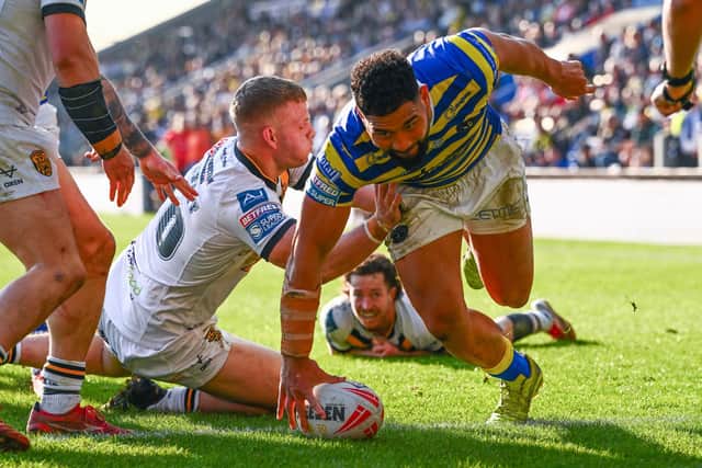Playing from behind: Castleford Tigers players can only watch in despair as Kelepi Tanginoa scores another Warrington try.