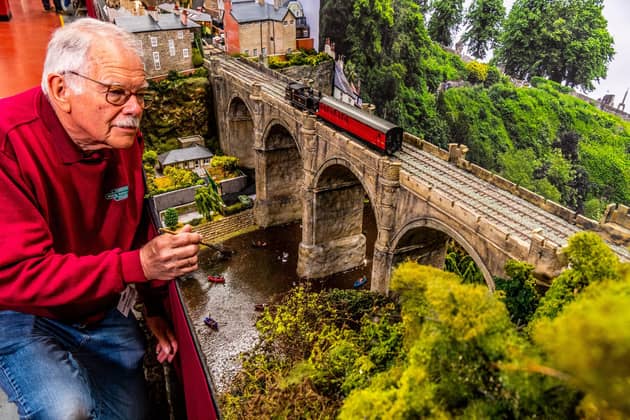 Graham Warren, Secretary of the Harrogate Model Railway Group, with his layout of The Knaresborough Viaduct over River Nidd with pleasure boaters below.