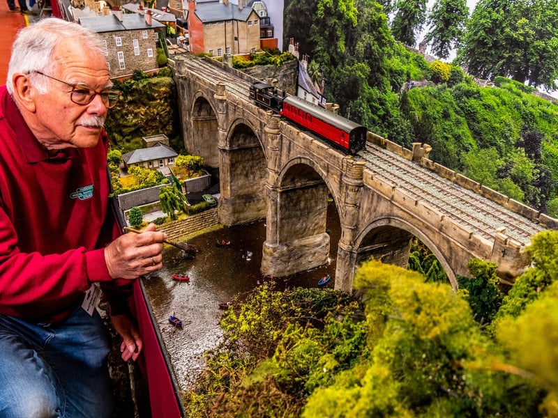 Graham Warren, Secretary of the Harrogate Model Railway Group, with his layout of The Knaresborough Viaduct over River Nidd with pleasure boaters below.