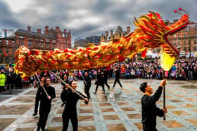 The wakening of the Loin by Sheffields Chinese Lion Dance Team which started outside Sheffield Town Hall and finished in the Peace Gardens watch by hundreds of people.