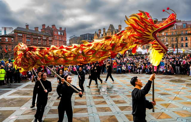 The wakening of the Loin by Sheffields Chinese Lion Dance Team which started outside Sheffield Town Hall and finished in the Peace Gardens watch by hundreds of people.
