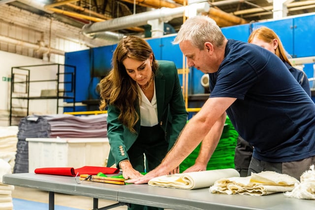 Her Royal Highness The Princess of Wales looking at a sample of green fabric whilst chatting with Philip Pickard, Wet Processing Assistant Manager for A W Hainsworth & Sons Ltd. Picture By Yorkshire Post Photographer,  James Hardisty.