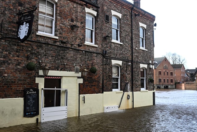The side of a pub on a street flooded by the River Ouse as the the tenth named storm this season battered down on the UK.