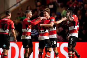 Doncaster Rovers’ Joe Ironside (second right) celebrates scoring the opening goal with his team mates during the Carabao Cup second round match at the Eco-Power Stadium, Doncaster. Picture date: Wednesday August 30, 2023. PA Photo. See PA story SOCCER Doncaster. Photo credit should read: Mike Egerton/PA Wire.RESTRICTIONS: EDITORIAL USE ONLY No use with unauthorised audio, video, data, fixture lists, club/league logos or "live" services. Online in-match use limited to 120 images, no video emulation. No use in betting, games or single club/league/player publications.