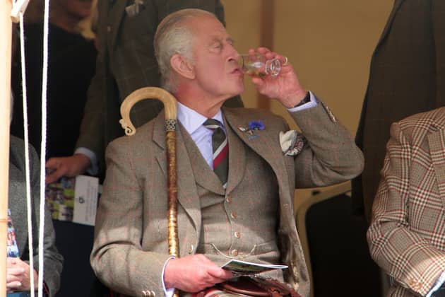King Charles III enjoys a dram during the Mey Highland Games at the John O'Groats Showground in Caithness. Photo by Robert MacDonald/PA Wire
