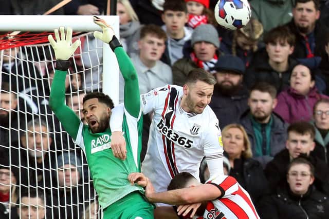 AERIAL BATTLE. Stoke CIty's Nick Powell challenges Sheffield United goalkeeper Wes Foderingham