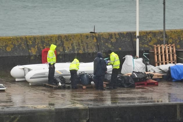Small boats and engines used by people thought to be migrants are inspected by Border Force officials in Dover, Kent. PIC: Gareth Fuller/PA Wire