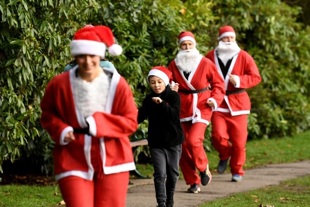 ‘Santas’ shown running the 5k in Haworth Central Park.