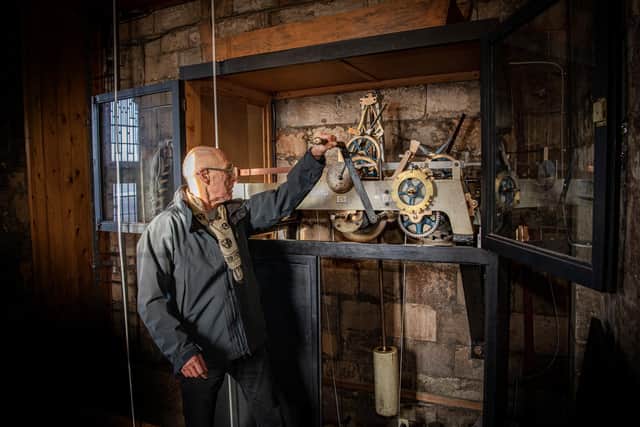 Tony Rugg winds the clockwork mechanism on the St Martin's clock on Coney Street cared for by the York Clock Group photographed for The Yorkshire Post Magazine by Tony Johnson.