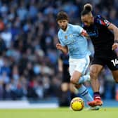 COUNTER-THREAT: Huddersfield Town centre-forward Sorba Thomas runs at Ruben Dias