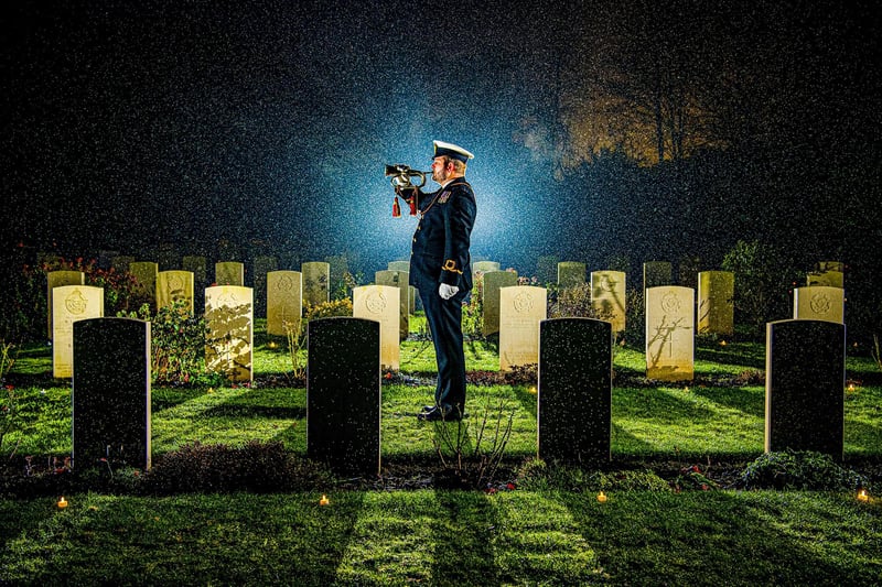 SLt (SCC) Dan Wilding RNR plays the last post at the Candlelit Christmas Remembrance event held at the Commonwealth War Graves Commission’s (CWGC) Stonefall Cemetery in Harrogate. 18 December 2022.