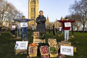 Riverford founder Guy Singh-Watson  in front of 49 scarecrows outside the Houses of Parliament in London, as part of Riverford's 'Get Fair About Farming' campaign, calling for the Government to force the leading supermarkets to adopt fairer principles for British farmers. Photo credit: David Parry/PA Wire