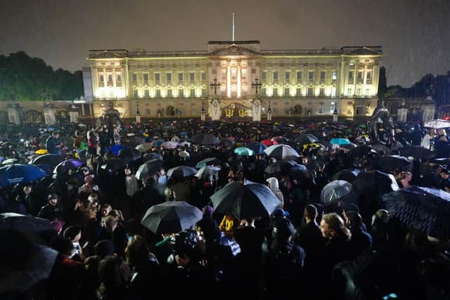 Members of the public gather outside Buckingham Palace in central London, following the announcement of the death of Queen Elizabeth II