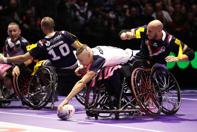 MANCHESTER, ENGLAND - NOVEMBER 18: Jack Brown of England goes over to score their sides fourth try during the Wheelchair Rugby League World Cup Final match between France and England at Manchester Central on November 18, 2022 in Manchester, England. (Photo by Charlotte Tattersall/Getty Images for RLWC)