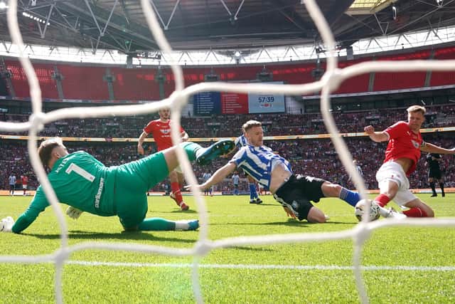 Barnsley goalkeeper Harry Isted (left) makes a save from Sheffield Wednesday's Michael Smith (centre right) during the Sky Bet League One play-off final at Wembley Stadium, London. Picture date: Monday May 29, 2023. PA Photo. See PA story SOCCER Final. Photo credit should read: Nick Potts/PA Wire.

RESTRICTIONS: EDITORIAL USE ONLY No use with unauthorised audio, video, data, fixture lists, club/league logos or "live" services. Online in-match use limited to 120 images, no video emulation. No use in betting, games or single club/league/player publications.