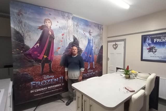 Paul at home with his 8ft tall Frozen banners