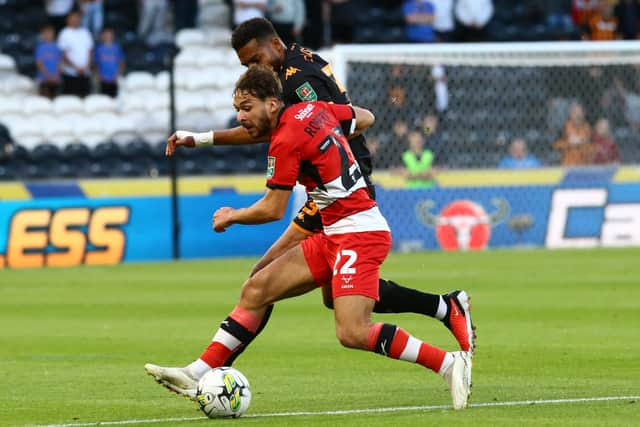 CHALLENGE: Doncaster Rovers summer signing Tyler Roberts competes with Cyrus Christie