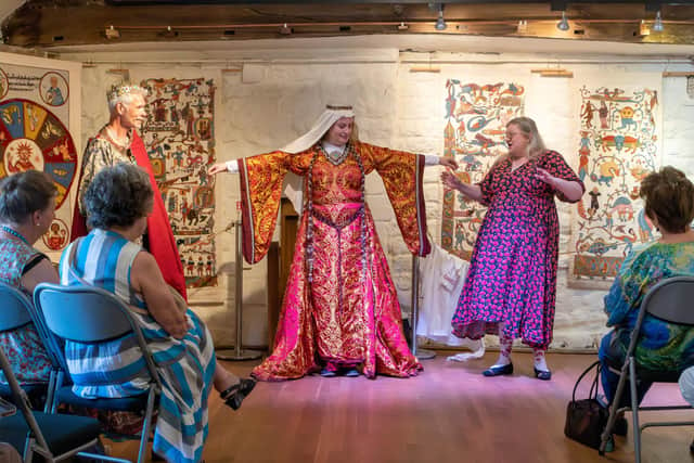 Tanya Bentham, right, with Dr Marta Cobb of Leeds University wearing a 12th century Norman court gown, or bliaud, on stage at Ilkley Manor House. Tanya says: “The whole point of that dress is saying, look, I don't work, I have servants doing things for me.” Far left, Paul Bromley wears a gown in silk brocade made by Sartor with a double-headed eagle design, an imperial symbol of power throughout Europe. Picture by Laura Mate.