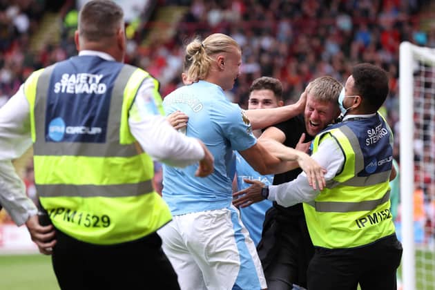 When Erling Haaland opened the scoring for Manchester City against Sheffield United, he was jumped on by an enthusiastic fan. Image: Alex Livesey/Getty Images
