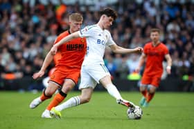 LEEDS, ENGLAND - MARCH 17: Archie Gray of Leeds United is challenged by Zian Flemming of Millwall during the Sky Bet Championship match between Leeds United and Millwall at Elland Road on March 17, 2024 in Leeds, England. (Photo by Ed Sykes/Getty Images)