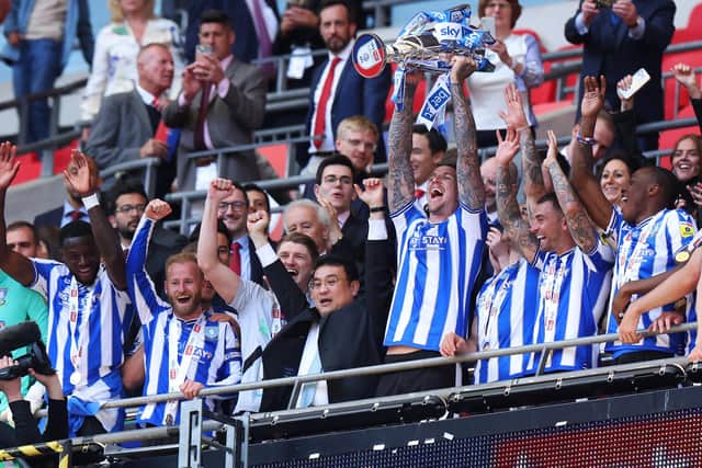 ON THE UP: Sheffield Wednesday chairman Dejphon Chansiri celebrates with his players and the League One play-off final trophy after seeing his team defeat Barnsley at Wembley Stadium to secure promotion back to the Championship  Picture: Richard Heathcote/Getty Images.