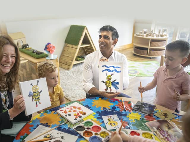 Prime Minister Rishi Sunak and Education Secretary Gillian Keegan hold images of bees they created during a visit to the Busy Bees nursery in Harrogate, North Yorkshire.
