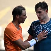 Opposite ends: Spain's Rafael Nadal greets Britain's Jack Draper (R) after winning their men's singles match on day one of the Australian Open (Picture: WILLIAM WEST/AFP via Getty Images)
