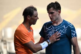 Opposite ends: Spain's Rafael Nadal greets Britain's Jack Draper (R) after winning their men's singles match on day one of the Australian Open (Picture: WILLIAM WEST/AFP via Getty Images)