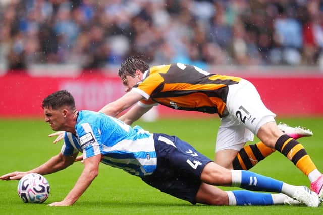 AT A STRETCH: Former Barnsley defender Bobby Thomas challenges Hull City's Elliot Stroud (right) (Image: Press Association)