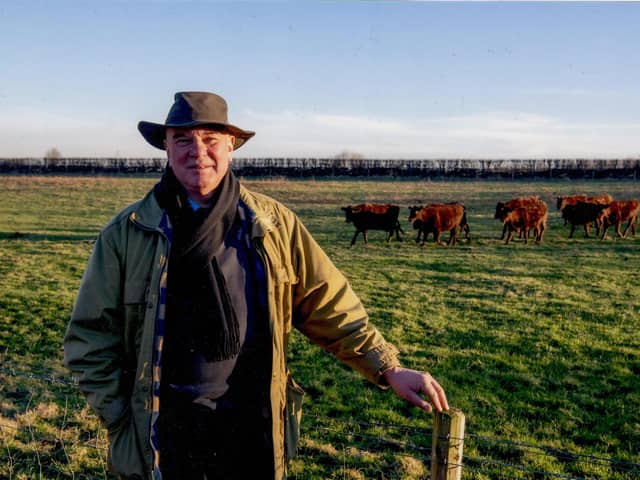 Owner of Tyers Hall Farm in Barnsley, Jimmy Dickinson, with Red Poll cows in 2024.