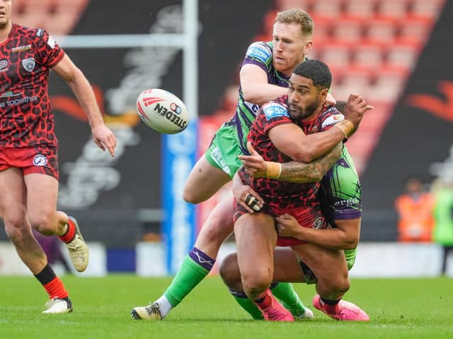 HONOURS EVEN: Leigh Centurions' Ricky Leutele offloads the ball under pressure from Castleford Tigers' Joe Westerman on Saturday. Picture by Olly Hassell/SWpix.com