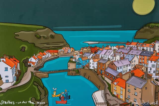 Work by Illustrator Sarah Westwood featuring her dog Sprocket who is incorporated into her designs, illustrations, ceramics etc - which feature scenes from all around Yorkshire including Staithes and Scarborough. Photograph by Tony Johnson.