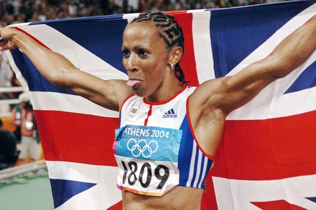Britain's Kelly Holmes holds up her national flag after she won gold in the women's 1500m final, 28 August 2004, during the Olympic Games (Picture: ERIC FEFERBERG/AFP via Getty Images)