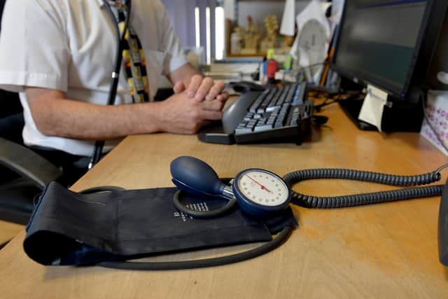 A GP sat at their desk. PIC: Anthony Devlin/PA Wire