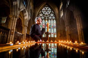 The Very Reverend John Dobson, Dean of Ripon, pictured reflecting on the last two years by lighting in candle.
