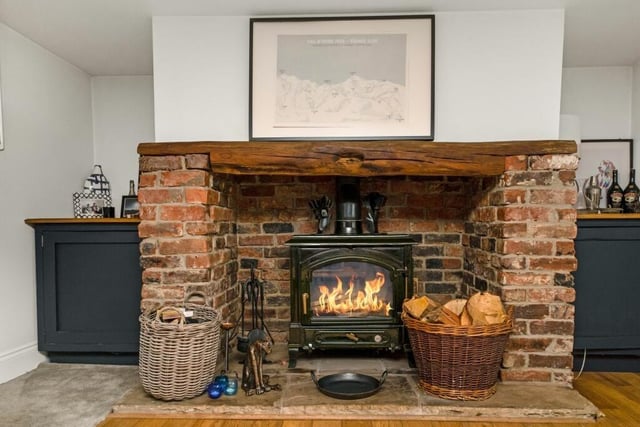 A close up of a wood burner in the brick hearth
