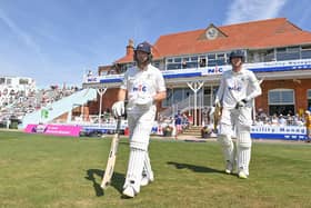 George Hill, right, pictured walking out to bat at North Marine Road, Scarborough.