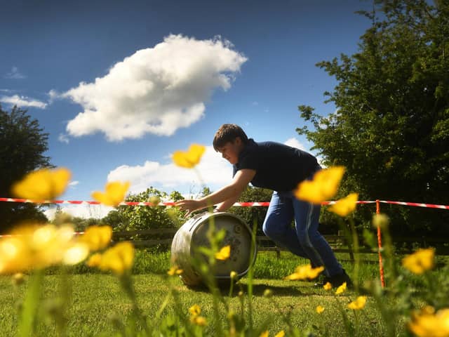 The Finghall Barrell Push. Competitors take part in the event in the village Finghall. Picture taken by Yorkshire Post Photographer Simon Hulme 27th May 2024