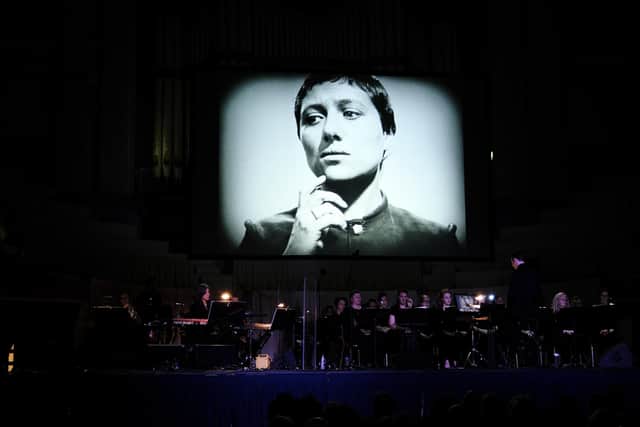 Julia Holter performing her live score for The Passion of Joan of Arc, with her band featuring Sarah Belle Reid (trumpet, electronics and vocals), and the Chorus of Opera North under conductor Hugh Brunt at Huddersfield Town Hall for hcmf//. Picture: Brian Slater